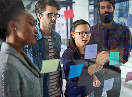 Team, brainstorming and notes on glass in office for schedule or daily routine for tasks or targets. Employees, window and creative designers looking on calendar for projects, timelines and goals. © peopleimages.com