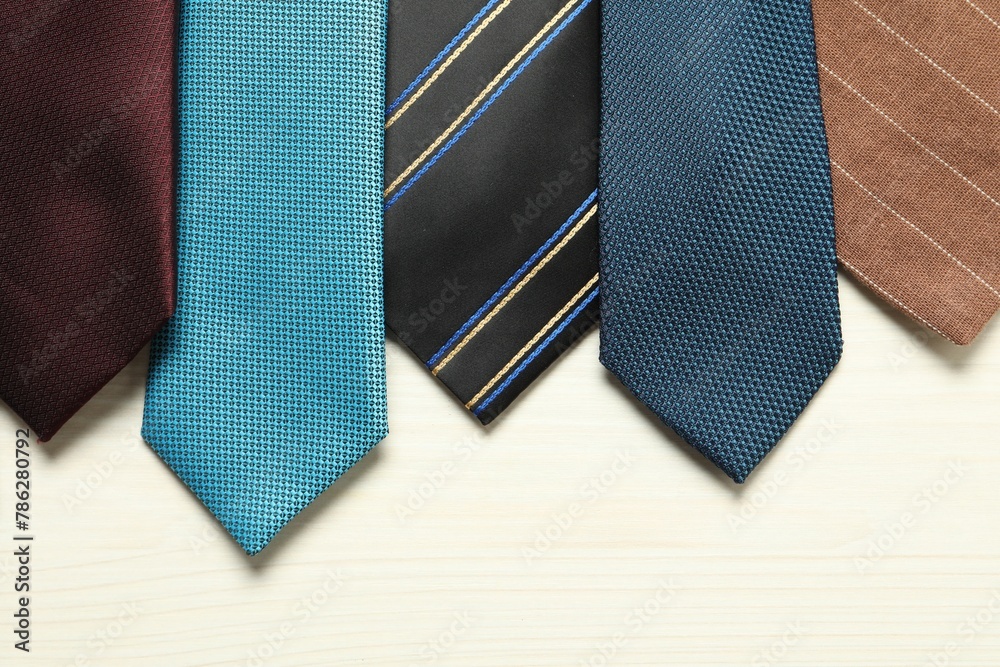 Different neckties on white wooden table, flat lay Different neckties on white wooden table, flat lay
