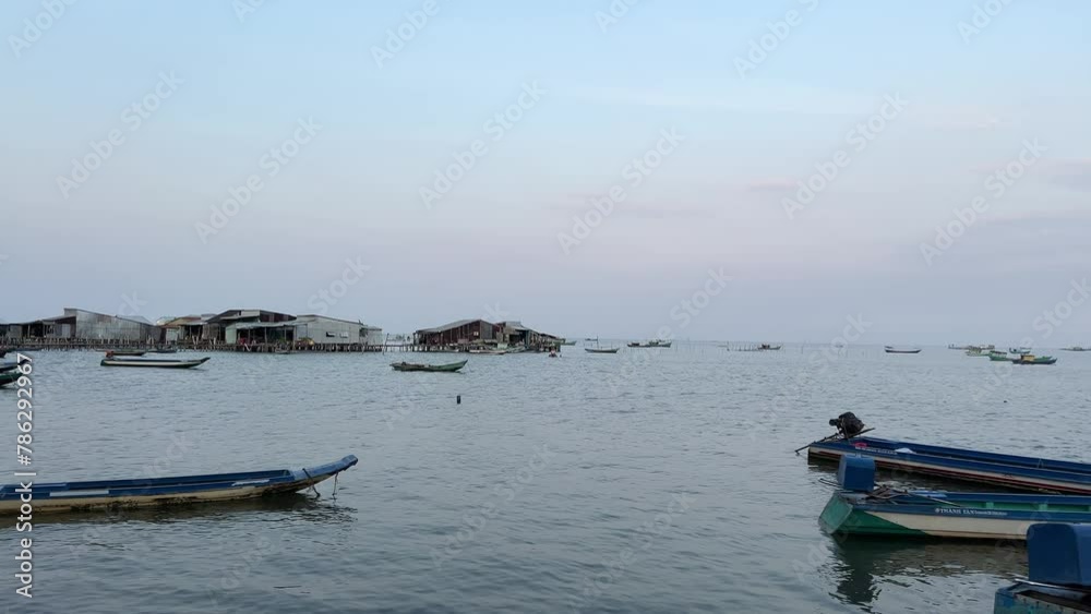 Palm trees untouched nature and garbage washed ashore boats . Vietnam phu Quoc island. beauty and dirt of poor life in Vietnam on the island. Fishing boats on the water of the Indian Ocean Palm trees untouched nature and garbage washed ashore boats . Vietnam phu Quoc island. beauty and dirt of poor life in Vietnam on the island. Fishing boats on the water of the Indian Ocean