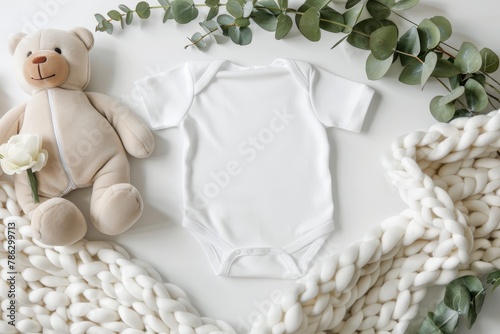 Infant bodysuit mockup with teddy bear and eucalyptus on ivory blanket for design template