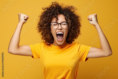 Ecstatic woman shout loud yeah fist up raise win lottery isolated bright shine color background photo