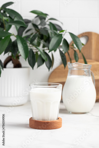 glass and jug of milk in a bright kitchen  dairy products  calcium