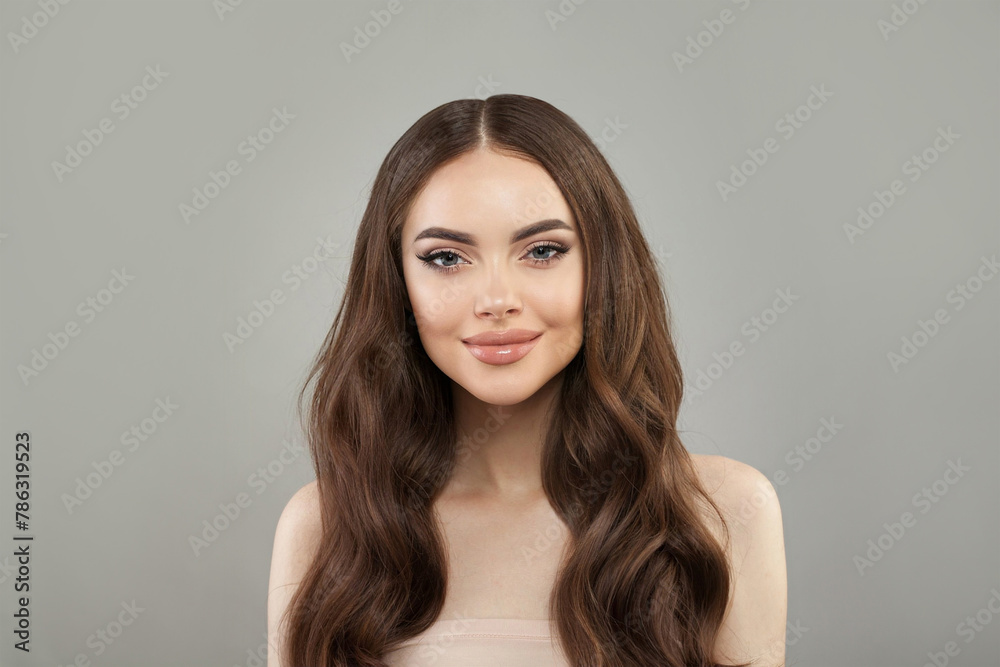 Pretty young happy woman model with natural make-up, clean healthy fresh skin and long hair posing on white background. Curly, haircare, skincare and facial treatment concept Pretty young happy woman model with natural make-up, clean healthy fresh skin and long hair posing on white background. Curly, haircare, skincare and facial treatment concept