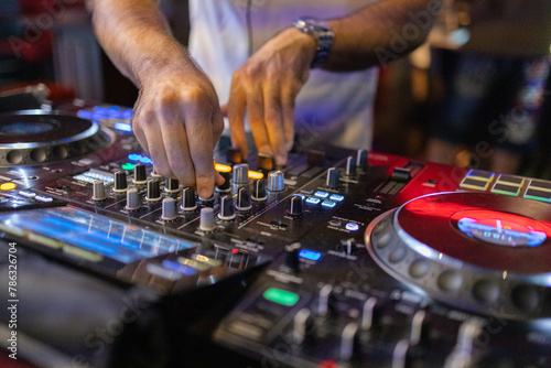 DJ's Hands Adjusting Music Mixer at Event © Sathit Trakunpunlert