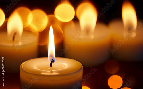 burning candle against bokeh background close-up