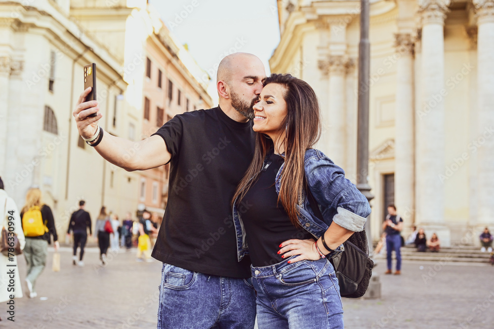 Happy  Beautiful Tourists  couple traveling at Rome, Italy, taking a selfie portrait Visiting Italy - man and woman enjoying weekend vacation - Happy lifestyle concept 