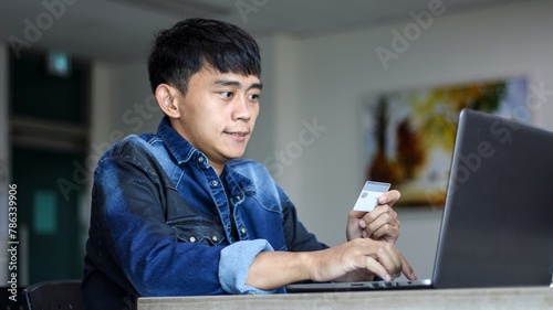 close up of man with laptop computer and credit card at home. technology, shopping, banking, home and lifestyle concept	