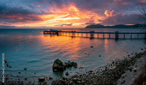 Sunrise over llandudno Pier with the tide in photo