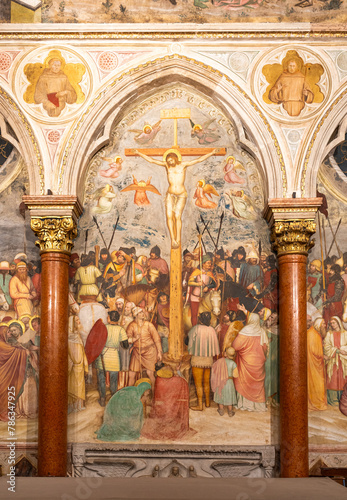 Large decorative wall fresco representing Jesus´ crucifixion inside gothic church in Italy
