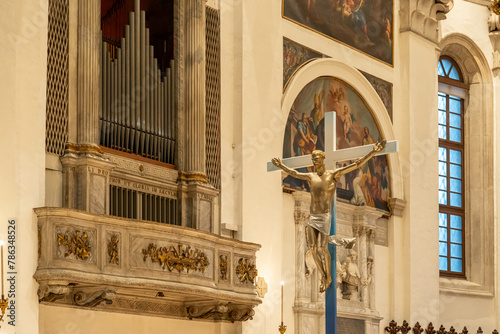 View of organ and big crucifix inside catholic church in Italy