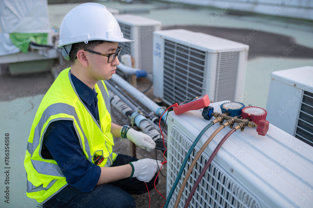Fototapeta premium Refrigeration and Air Conditioning Engineering Detects Plant Cooling Problems,electrician maintenance Condensing on the rooftop outdoors of large industrial building