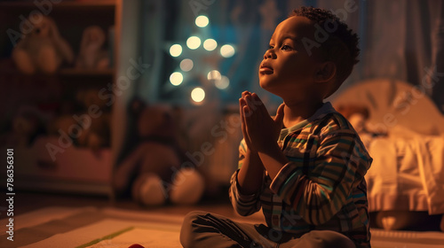 Boy prays to god in dark children room