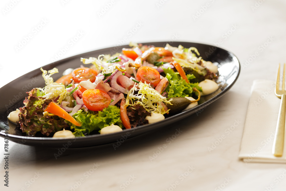 Fresh Vegetable Salad on black plate Fresh Vegetable Salad on black plate