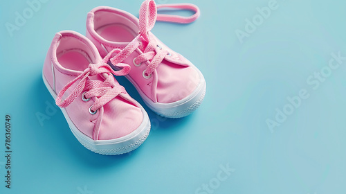 A pair of pink sneakers on a blue background.