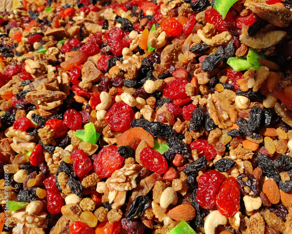 A mixture of colorful dried walnuts, cashews, hazelnuts and fruits, cherries, grapes, figs and kiwi A mixture of colorful dried walnuts, cashews, hazelnuts and fruits, cherries, grapes, figs and kiwi