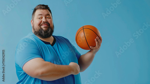 Bearded man in a blue jersey smiling with a basketball, blue background