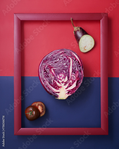 Cabbage, eggplant and tomato in wooden picture frame