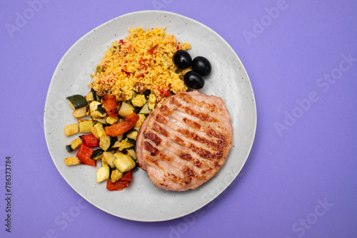 Delicious grilled chicken burgers served with baked vegetables