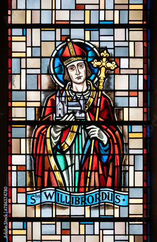 Saint Willibrord, the Apostle to the Frisians. A stained-glass window in Église de la Sainte-Trinité (Holy Trinity Church) in Walferdange, Luxembourg. photo