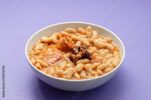 fabada asturiana, a typical spanish bean stew in white bowl