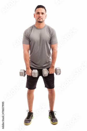 Young Hispanic Man Sporty Outfit Raising Dumbbells Strengthen His Deltoids White Background