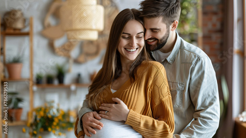 Happy pregnant woman with her husband indoors  photo