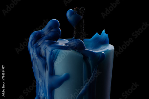 Burnt out blue candle in melted wax on black background