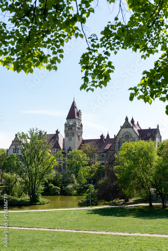 Medieval building with a clock in a tower in Spring Park  © Maryia