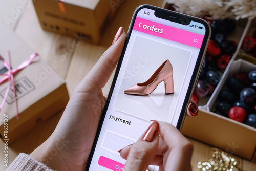 Online shopping: user ordering shoes, clothes and accessories with e commerce web site using a mobile app, home delivery concept photo