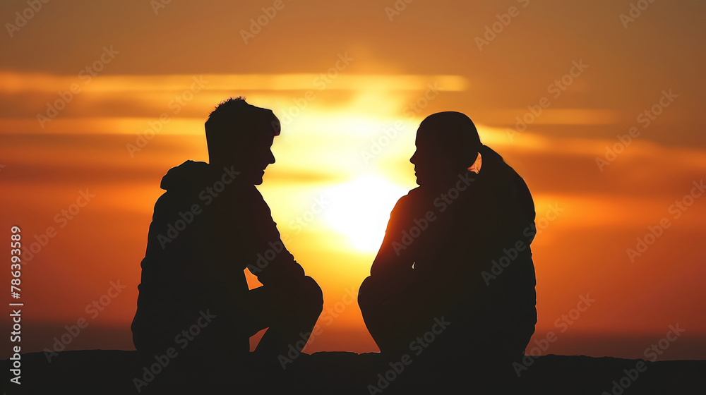 A couple is silhouetted against a sunset, with the woman's hair in a ponytail