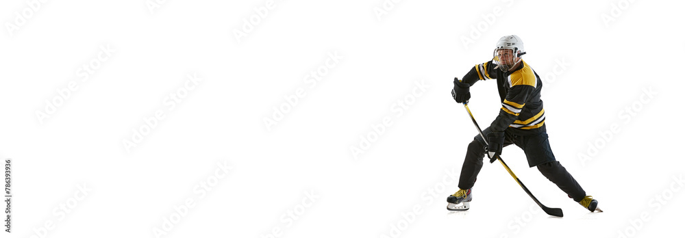 Φωτογραφία Man in uniform and helmet, focused hockey player in motion with stick, training isolated on white background