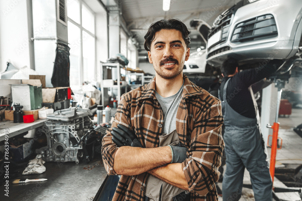 Portrait of a male mechanic in an auto repair shop Portrait of a male mechanic in an auto repair shop