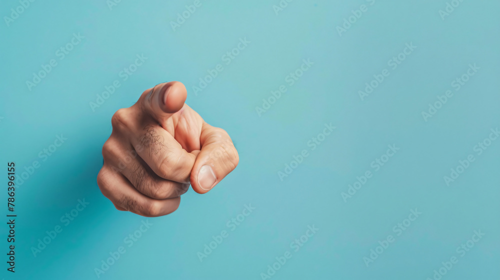 Man pointing with index finger on light blue background