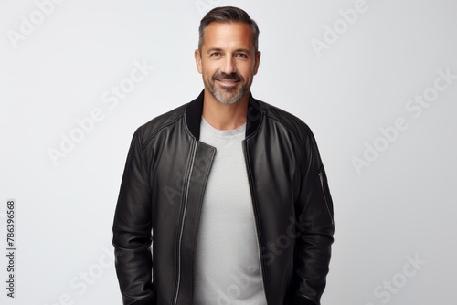 Portrait of a satisfied man in his 40s wearing a trendy bomber jacket in white background