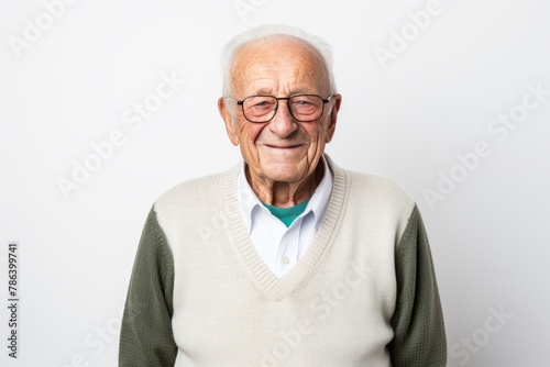 Portrait of a cheerful elderly man in his 90s wearing a chic cardigan in white background