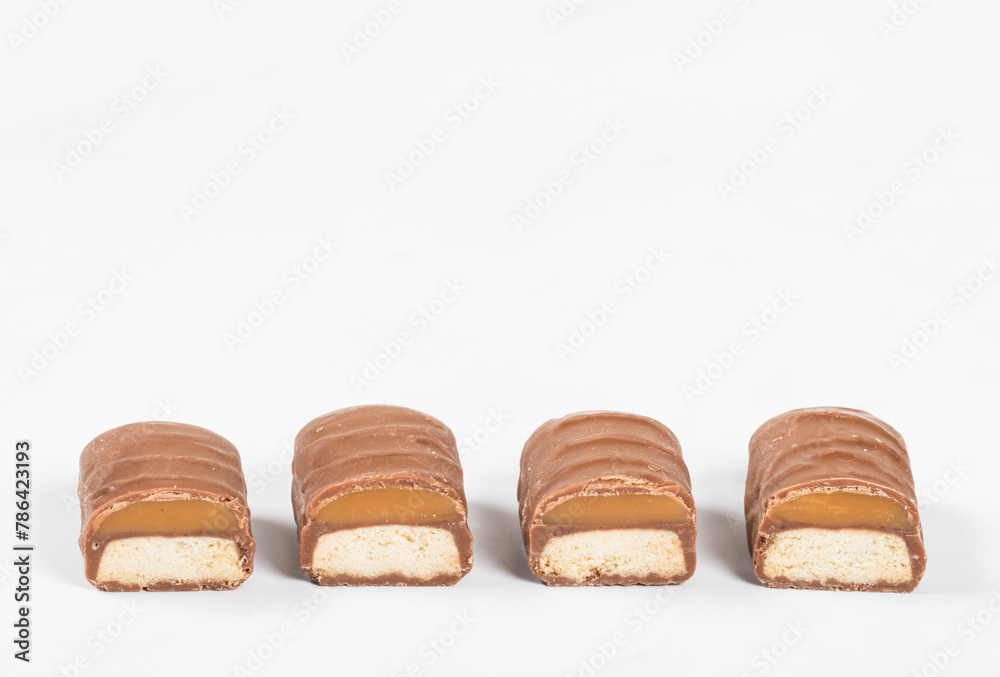 Cookies with caramel in chocolate glaze. In the section. White background. Close-up. Copy space Cookies with caramel in chocolate glaze. In the section. White background. Close-up. Copy space