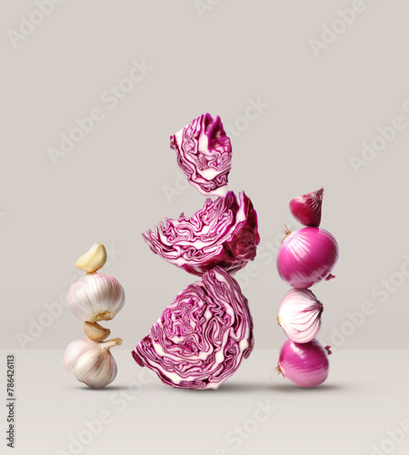 Creative layout made of red cabbage, red onion and garlic on the beige background. Food concept. Macro concept.