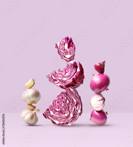 Creative layout made of red cabbage, red onion and garlic on the purple background. Food concept. Macro concept.