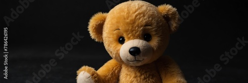 cute yellow teddy bear stuff toy on plain black background from Generative AI © Arceli