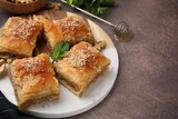 Eastern sweets. Pieces of tasty baklava on brown table, closeup. Space for text