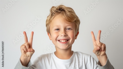 Cheerful Youngster: 10-Year-Old American Flashing a Victory Sign © Andrii 