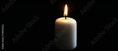 The image of a white candle on a black background is isolated