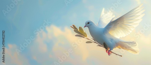 A white dove carries a leaf branch against a blue sky background to commemorate the 2017 International Day of Peace photo