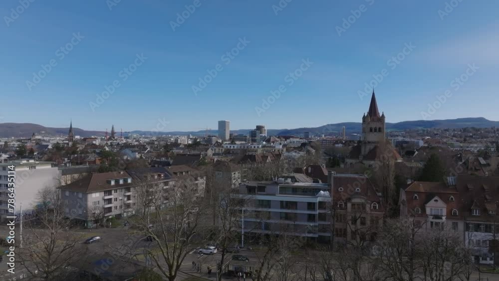 Forwards fly above buildings and streets in urban borough. Aerial view of city under clear sky. Basel, Switzerland Forwards fly above buildings and streets in urban borough. Aerial view of city under clear sky. Basel, Switzerland