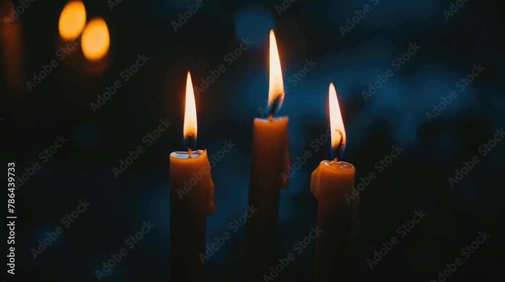 Candles lit against a dark backdrop