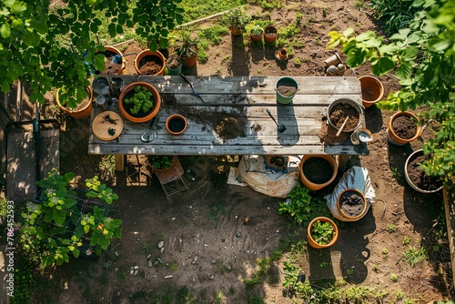 Top-down view of a messy garden table with various pots and gardening tools, highlighting the beauty of chaos in nature's embrace.