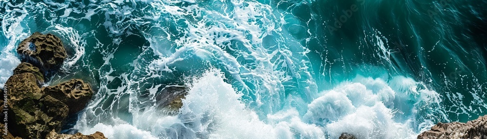 Fototapeta premium Teal ocean waves crashing on olive green cliffs, navy blue horizon.