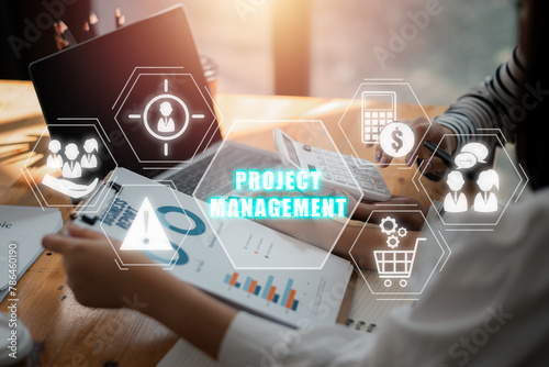 Project management concept, Business team analyzing income charts and graphs on office desk with human resources, risk, scope, cost, procurement and communication icon on virtual screen.