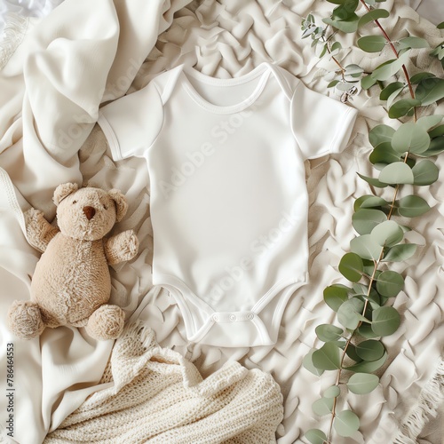 Elegant infant clothing mockup, top view of a white cotton baby bodysuit, alongside a teddy bear and a eucalyptus branch, on a soft ivory throw blanket, shot from DSLR, Realistic.