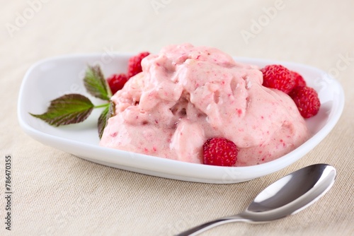 Raw vegan banana ice cream with raspberries.